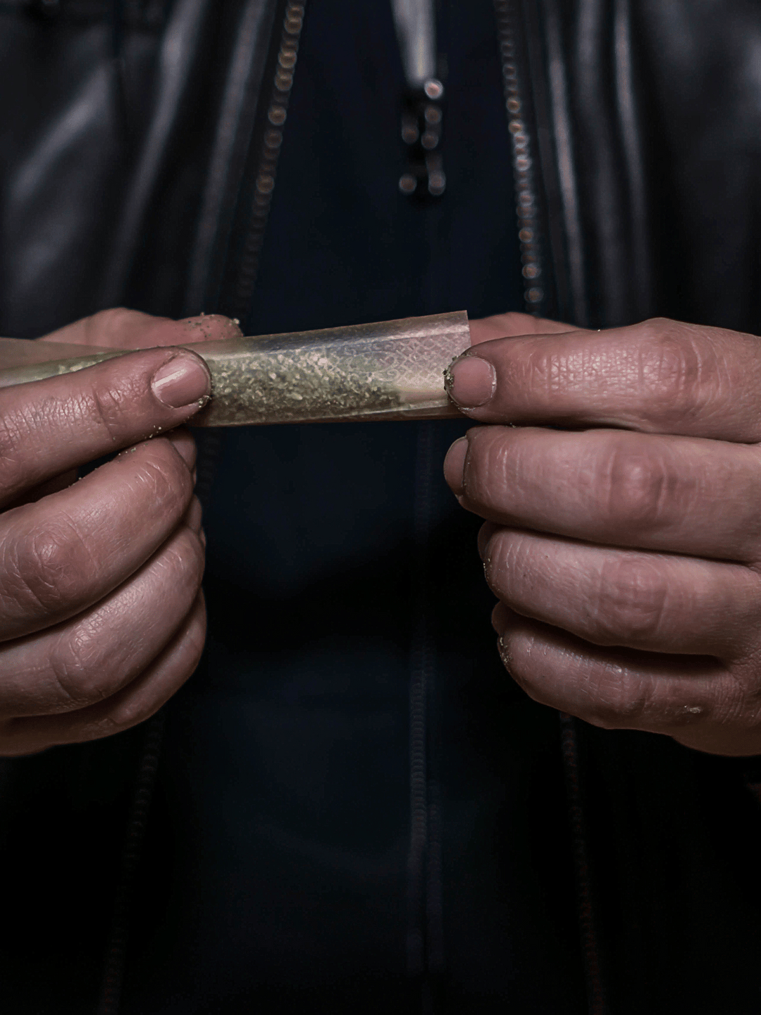 Two hands rolling a Joint